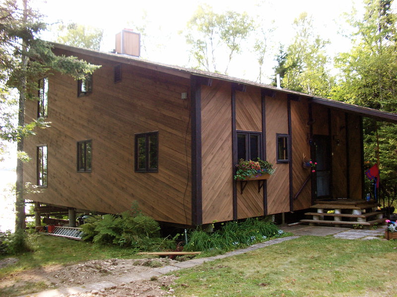 Side of the house, with the sea bleached out on the left.