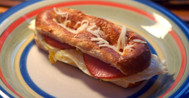 Philadelphia = the City of Love. Or at least that's what it's named for. This = the Breakfast of Love. 1 soft pretzel 2 eggs 2 slices canadian bacon (or bacon, or scrapple if that's your bag) However much cheese you see fit.
And trust me, it tastes alot better than it looks, even though I think it doesn't look half bad.