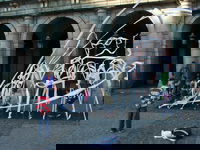 In La Plaza Mayor today a lady took the wind coming from a subway grate and turned it into a plaything for some nearby kids.