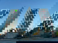 The two buildings that make up Puerta de Europa are built at 135 degrees and 15 degrees, respectively, to signify the opening of a doorway to Europe. Unfortunately, the statue and the large cut of stone are not aligned with the buildings, so getting a really accurate sense of symmetry here is almost impossible. Although I'll add that there's no real excuse for not having a level picture. Plaza de Castillana, Madrid. 