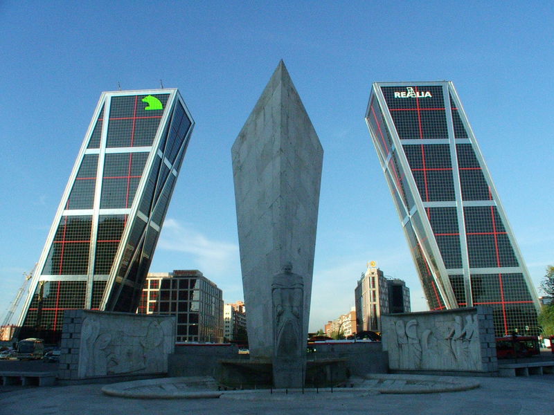 The two buildings that make up Puerta de Europa are built at 135 degrees and 15 degrees, respectively, to signify the opening of a doorway to Europe. Unfortunately, the statue and the large cut of stone are not aligned with the buildings, so getting a really accurate sense of symmetry here is almost impossible. Although I'll add that there's no real excuse for not having a level picture. Plaza de Castillana, Madrid. 