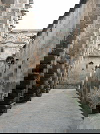 To the left is the right wall of the cathedral of Ávila. The wall in the background is the wall at Ávila, the second largest city wall still intact in the world.