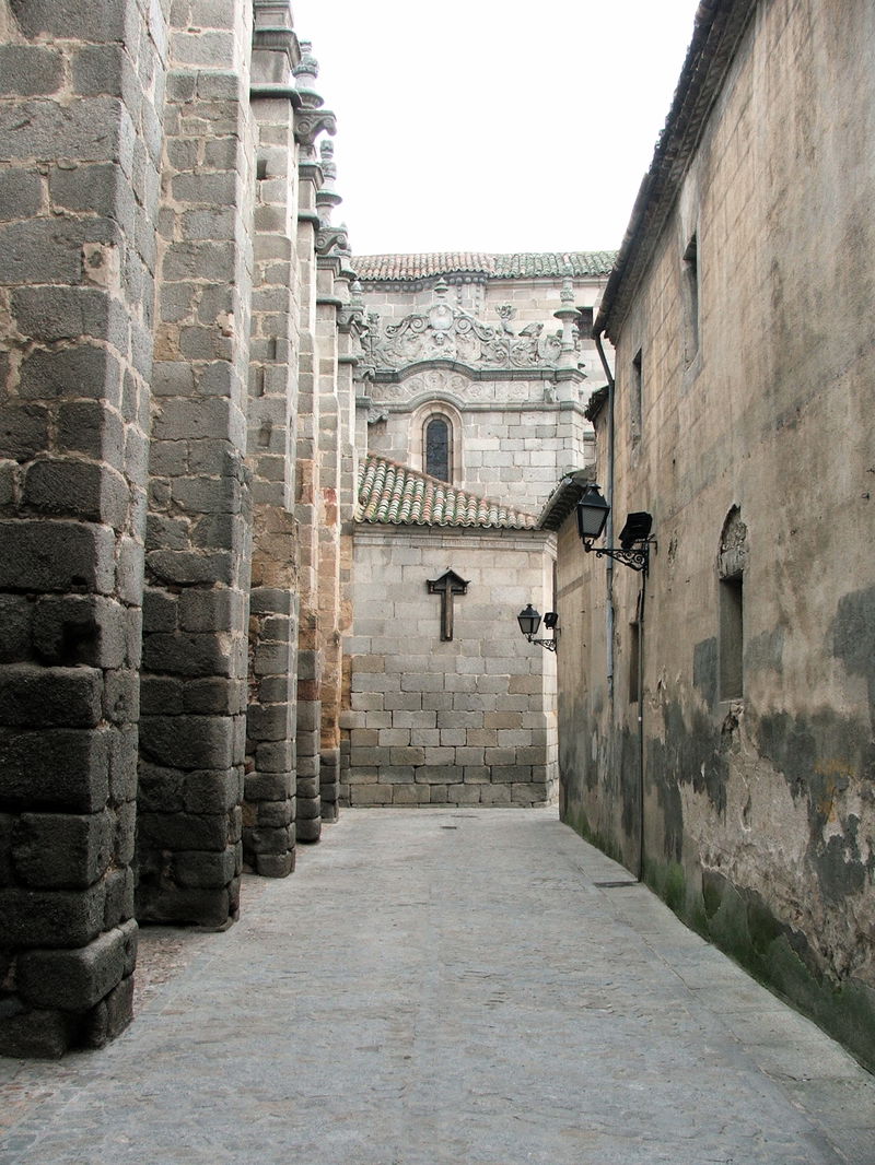To the left is the right wall of the cathedral of Ávila. The wall in the background is the wall at Ávila, the second largest city wall still intact in the world.